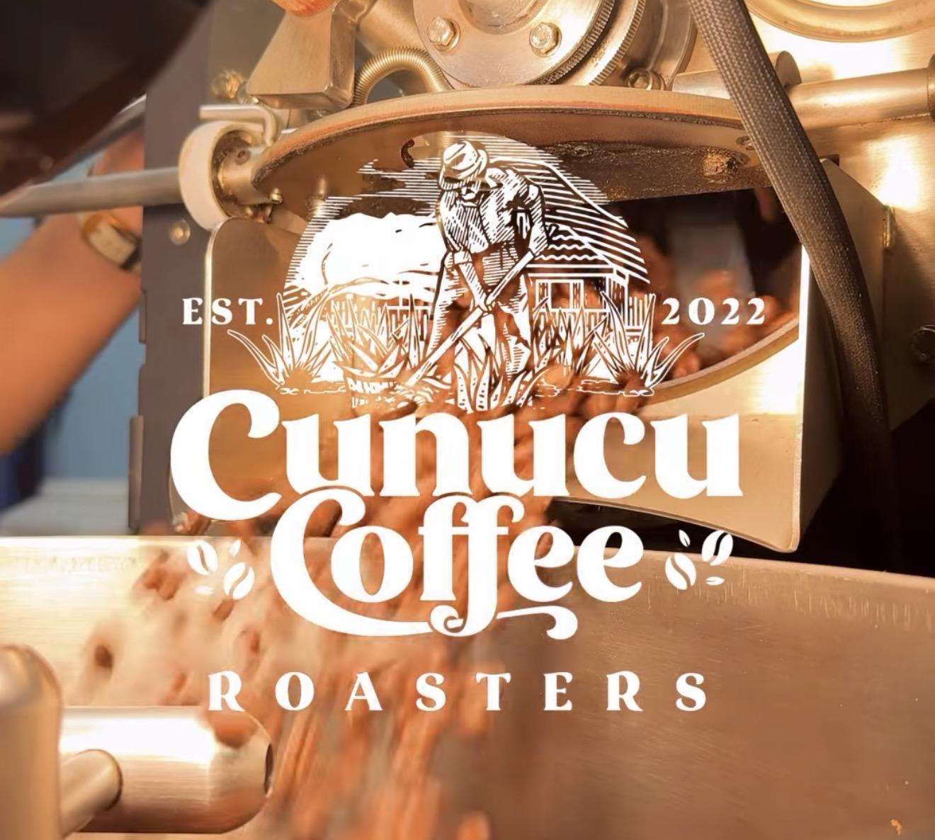 Cunucu Coffee Roasters logo in front of a coffee roasting drum