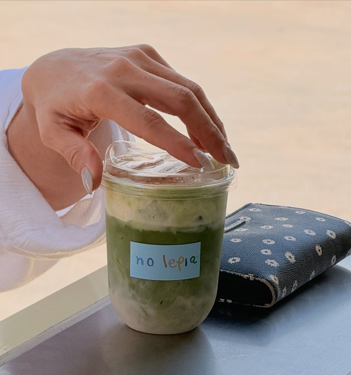 Creamy oat milk matcha iced latte with honey cinnamon cream top